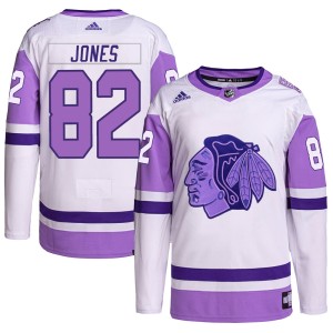 Caleb Jones Youth Adidas Chicago Blackhawks Authentic White/Purple Hockey Fights Cancer Primegreen Jersey